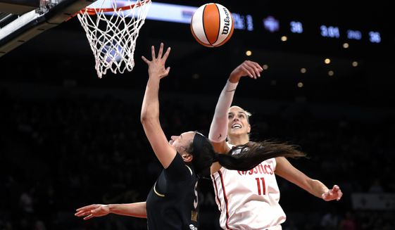 A shot by Las Vegas Aces forward Dearica Hamby (5) is rejected by Washington Mystics forward Elena Delle Donne (11) during the first half of a WNBA basketball game Saturday, June 25, 2022, in Las Vegas. (Steve Marcus/Las Vegas Sun via AP)