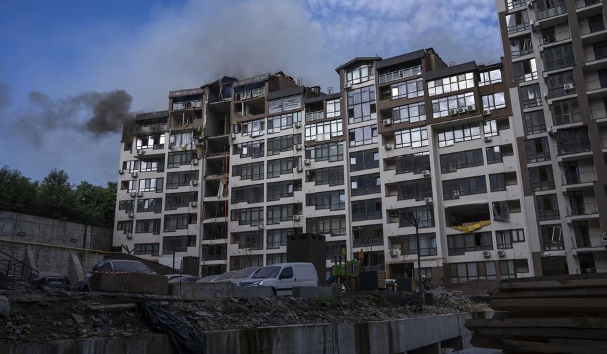 Smoke billows the air from a residential buildings following explosions, in Kyiv, Ukraine, Sunday, June 26, 2022. Several explosions rocked the west of the Ukrainian capital in the early hours of Sunday morning, with at least two residential buildings struck, according to Kyiv mayor Vitali Klitschko. (AP Photo/Nariman El-Mofty)