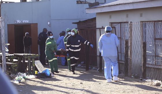 A body is removed from a nightclub in East London, South Africa, Sunday June 26, 2022. South African police are investigating the deaths of at least 20 people at a nightclub in the coastal town of East London early Sunday morning. It is unclear what led to the deaths of the young people, who were reportedly attending a party to celebrate the end of winter school exams. (AP Photo)