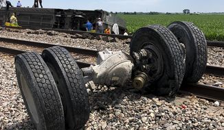 In this photo provided by Dax McDonald, debris sits near railroad tracks after an Amtrak passenger train derailed near Mendon, Mo., on Monday, June 27, 2022. The Southwest Chief, traveling from Los Angeles to Chicago, was carrying about 243 passengers when it collided with a dump truck near Mendon, Amtrak spokeswoman Kimberly Woods said. (Dax McDonald via AP)