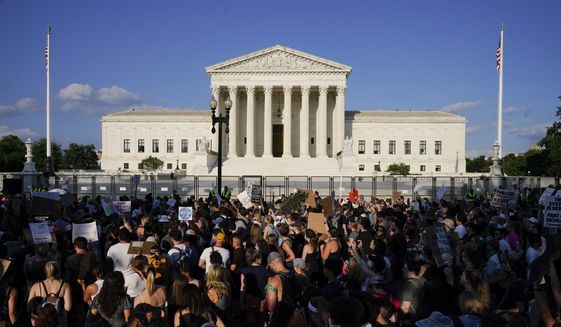 Protesters fill the street in front of the Supreme Court after the court&#39;s decision to overturn Roe v. Wade in Washington, June 24, 2022. Public opinion on abortion is nuanced, but polling shows broad support for Roe and for abortion rights. Seventy percent of U.S. adults said in a May AP-NORC poll that the Supreme Court should leave Roe as is, not overturn it. (AP Photo/Jacquelyn Martin)