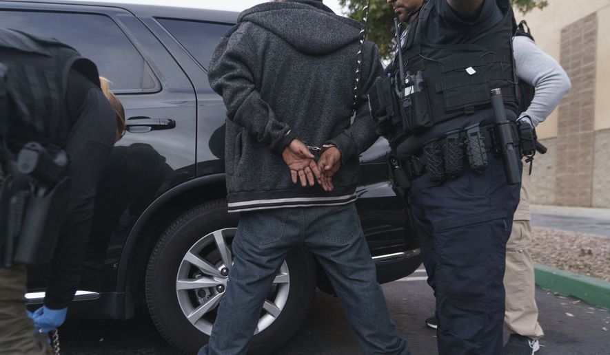 U.S. Immigration and Customs Enforcement agents arrest an immigrant considered a threat to public safety and national security during an early morning raid in Compton, Calif., Monday, June 6, 2022. (AP Photo/Damian Dovarganes) ** FILE **