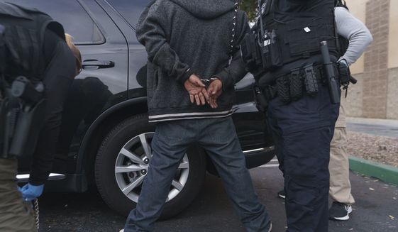 U.S. Immigration and Customs Enforcement agents arrest an immigrant considered a threat to public safety and national security during an early morning raid in Compton, Calif., Monday, June 6, 2022. This weekend, the Biden administration said it would suspend an order prioritizing the arrest and deportation of immigrants considered a threat to public safety and national security in order to comply with a ruling earlier in June 2022 from a Texas judge. Many otherwise law-abiding immigrants living here illegally will now be afraid to leave their homes out of concern they&#39;ll be detained. (AP Photo/Damian Dovarganes)