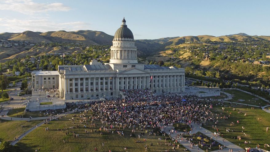 People attend an abortion-rights protest at the Utah State Capitol, Friday, June 24, 2022, in Salt Lake City. The U.S. Supreme Court's decision to end constitutional protections for abortion has cleared the way for states to impose bans and restrictions on abortion — and will set off a series of legal battles.(AP Photo/Rick Bowmer)