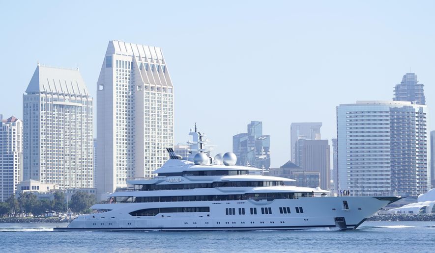 The super yacht Amadea passes San Diego as it comes into the San Diego Bay Monday, June 27, 2022, seen from Coronado, Calif. The $325 million superyacht seized by the United States from a sanctioned Russian oligarch arrived in San Diego Bay on Monday. (AP Photo/Gregory Bull)
