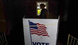 A person waits in line to vote in Georgia&#39;s primary election on May 24, 2022, in Atlanta. More than 1 million voters across 43 states have switched to the Republican Party over the last year, according to voter registration data analyzed by The Associated Press. (AP Photo/Brynn Anderson, File)