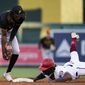 Washington Nationals&#x27; Josh Bell, right, is forced out at second base by Pittsburgh Pirates shortstop Oneil Cruz, left, during the third inning of a baseball game at Nationals Park, Monday, June 27, 2022, in Washington. (AP Photo/Alex Brandon)