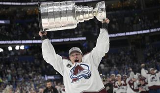 Colorado Avalanche defenseman Erik Johnson lifts the Stanley Cup after the team defeated the Tampa Bay Lightning in Game 6 of the NHL hockey Stanley Cup Finals on Sunday, June 26, 2022, in Tampa, Fla. (AP Photo/Phelan Ebenhack)
