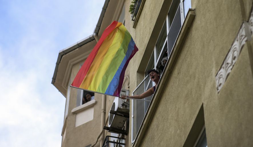 A woman waves a rainbow flag as she shouts slogans during the LGBTQ Pride March in Istanbul, Turkey, Sunday, June 26, 2022. Dozens of people were detained in central Istanbul Sunday after city authorities banned a LGBTQ Pride March, organizers said. (AP Photo/Emrah Gurel) ** FILE **