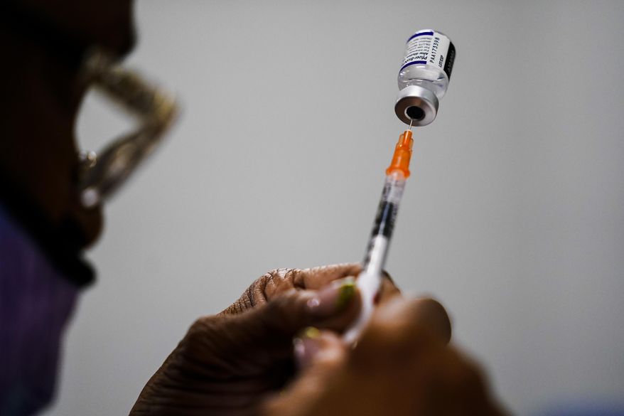A syringe is prepared with the Pfizer COVID-19 vaccine at a vaccination clinic at the Keystone First Wellness Center in Chester, Pa., Dec. 15, 2021. (AP Photo/Matt Rourke, File)