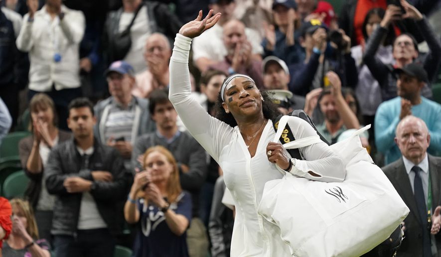 Serena Williams of the US waves as she leaves the court after losing to France&#x27;s Harmony Tan in a first round women&#x27;s singles match on day two of the Wimbledon tennis championships in London, Tuesday, June 28, 2022. (AP Photo/Alberto Pezzali)