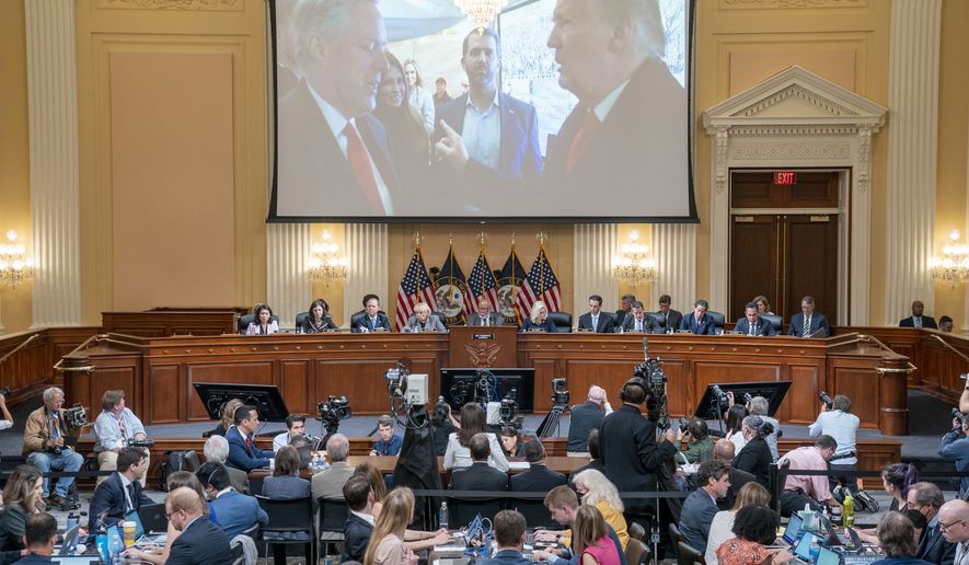 A image of former President Donald Trump talking to his Chief of Staff Mark Meadows is seen as Cassidy Hutchinson, former aide to Trump White House chief of staff Mark Meadows, testifies as the House select committee investigating the Jan. 6 attack on the U.S. Capitol holds a hearing at the Capitol in Washington, Tuesday, June 28, 2022. (Sean Thew/Pool via AP)