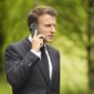 French President Emmanuel Macron speaks on a mobile phone as he walks to a media conference at the G-7 venue, Castle Elmau, in Kruen, Germany, on Tuesday, June 28, 2022. The Group of Seven leading economic powers are concluding their annual gathering on Tuesday. (AP Photo/Markus Schreiber)