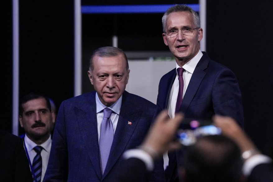 Turkish President Recep Tayyip Erdogan, second left, and NATO Secretary General Jens Stoltenberg before signing a memorandum in which Turkey agrees to Finland and Sweden&#x27;s membership of the defense alliance in Madrid, Spain on Tuesday, June 28, 2022. North Atlantic Treaty Organization heads of state will meet for a summit in Madrid from Tuesday through Thursday. (AP Photo/Bernat Armangue)