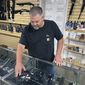 John Parkin, co-owner of Coyote Point Armory displays a handgun at his store in Burlingame, Calif., June 23, 2022. In response to the U.S. Supreme Court&#39;s ruling that allows more people to carry concealed weapons, California lawmakers, on Tuesday, June 28, 2022, moved to boost requirements and limit where firearms may be carried while staying within the high court&#39;s ruling. (AP Photo/Haven Daley, File)