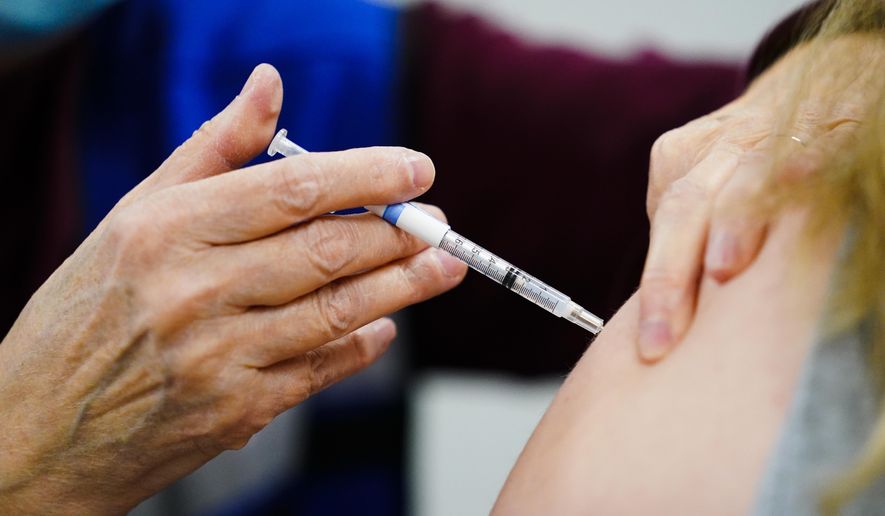 A health worker administers a dose of a COVID-19 vaccine during a vaccination clinic at the Keystone First Wellness Center in Chester, Pa., on Dec. 15, 2021. (AP Photo/Matt Rourke, File)