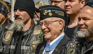 Hershel &quot;Woody&quot; Williams (center), the sole surviving U.S. Marine to be awarded the Medal of Honor during World War II, poses with fellow Marines at the Charles E. Shelton Freedom Memorial at Smothers Park, Saturday, April 6, 2019, in Owensboro, Ky. Williams, the last remaining Medal of Honor recipient from World War II, died Wednesday, June 29, 2022. He was 98. Williams&#39; foundation announced on Twitter and Facebook that he died at the Veterans Affairs medical center bearing his name in Huntington. (Greg Eans/The Messenger-Inquirer via AP) **FILE**