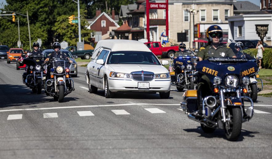 Law enforcement officers lead a procession for Hershel W. “Woody” Williams, the last remaining Medal of Honor recipient from World War II, Wednesday, June 28, 2022, in Huntington, W.Va. Williams, 98, died Wednesday at the Veterans Affairs medical center bearing his name in Huntington. As a young Marine corporal, Williams went ahead of his unit during the Battle of Iwo Jima in the Pacific Ocean in February 1945 and eliminated a series of Japanese machine-gun positions. (Sholten Singer/The Herald-Dispatch via AP)