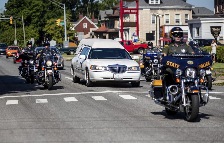 Law enforcement officers lead a procession for Hershel W. “Woody” Williams, the last remaining Medal of Honor recipient from World War II, Wednesday, June 28, 2022, in Huntington, W.Va. Williams, 98, died Wednesday at the Veterans Affairs medical center bearing his name in Huntington. As a young Marine corporal, Williams went ahead of his unit during the Battle of Iwo Jima in the Pacific Ocean in February 1945 and eliminated a series of Japanese machine-gun positions. (Sholten Singer/The Herald-Dispatch via AP)