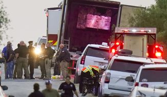 Police and other first responders work the scene where officials say dozens of people have been found dead and multiple others were taken to hospitals with heat-related illnesses after a semitrailer containing suspected migrants was found, Monday, June 27, 2022, in San Antonio. (AP Photo/Eric Gay)