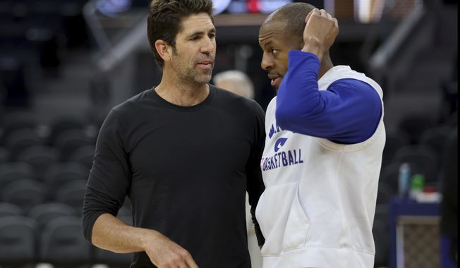 Golden State Warriors general manager Bob Myers, left, speaks with forward Andre Iguodala, right, during NBA basketball practice in San Francisco, Wednesday, June 1, 2022. The Warriors are scheduled to host the Boston Celtics in Game 1 of the NBA Finals on Thursday. (AP Photo/Jed Jacobsohn)