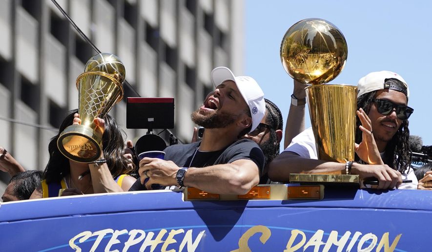 Stephen Curry and Damion Lee, right, ride in the Golden State Warriors NBA championship parade in San Francisco, Monday, June 20, 2022. (AP Photo/Eric Risberg) **FILE**