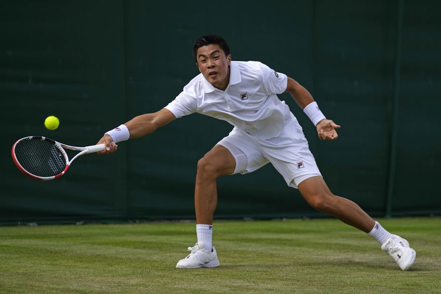 Brandon Nakashima of the US returns to Canada&#39;s Denis Shapovalov in a second round men&#39;s single match on day four of the Wimbledon tennis championships in London, Thursday, June 30, 2022. (AP Photo/Alastair Grant)