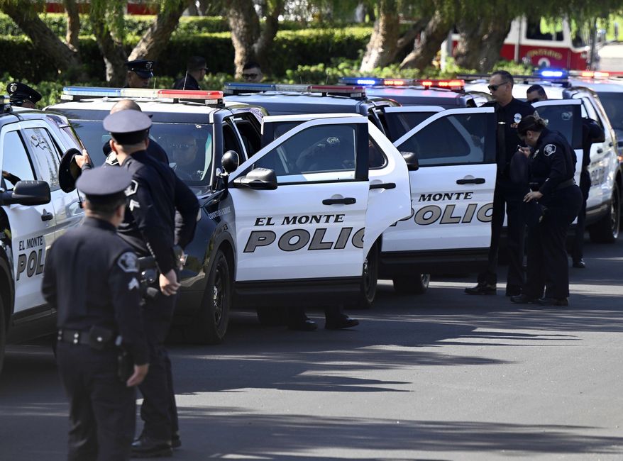 Members of the El Monte Police Department exit their patrol cars outside of Toyota Arena as they gather for the memorial service for El Monte Officer Joseph Santana and Sgt. Michael Paredes on Thursday, June 30, 2022, in Ontario, Calif. Both were shot and killed in the line of duty on June 14. (Will Lester/The Orange County Register via AP)
