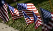 U.S. flags are placed in front of a house in Palatine, Ill., Thursday, June 30, 2022. (AP Photo/Nam Y. Huh)