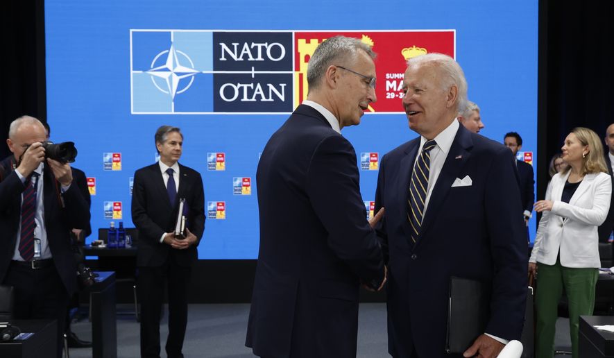 U.S. President Joe Biden and NATO Secretary General Jens Stoltenberg, right, talk during the Meeting of the North Atlantic Council Session with fellow heads of state at the NATO summit at the IFEMA arena in Madrid, Thursday, June 30, 2022. (Jonathan Ernst/Pool Photo via AP)