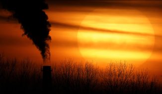 Emissions from a coal-fired power plant are silhouetted against the setting sun in Kansas City, Mo., on Feb. 1, 2021. The Supreme Court on Thursday, June 30, 2022, limited how the nation’s main anti-air pollution law can be used to reduce carbon dioxide emissions from power plants. By a 6-3 vote, with conservatives in the majority, the court said that the Clean Air Act does not give the Environmental Protection Agency broad authority to regulate greenhouse gas emissions from power plants that contribute to global warming. (AP Photo/Charlie Riedel) **FILE**