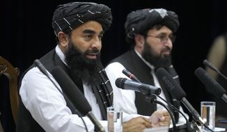 Zabiullah Mujahid, left, the spokesman for the Taliban government, speaks during a press conference in Kabul, Afghanistan, Thursday, June 30, 2022. Afghanistan&#39;s Taliban rulers held a gathering Thursday of some 3,000 Islamic clerics and tribal elders for the first time since seizing power in August, urging them to advise them on running the country. Women were not allowed to attend. (AP Photo/Ebrahim Noroozi)