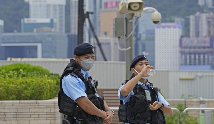 Police officers patrol outside the high speed train station for the Chinese president Xi Jinping&#39;s visit to mark the 25th anniversary of Hong Kong handover to China, in Hong Kong, Thursday, June 30, 2022. (AP Photo/Kin Cheung)