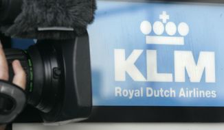 A cameraman films the Logo of Dutch airline KLM at the Cologne Bonn Airport in Cologne, western Germany, Sept. 26, 2008. Dutch flag carrier KLM announced Thursday, June 30, 2022 it is repaying the last portion of loans from the Netherlands government and banks to help it survive when the COVID-19 pandemic threw global aviation into a tailspin. (AP Photo/Roberto Pfeil, file)