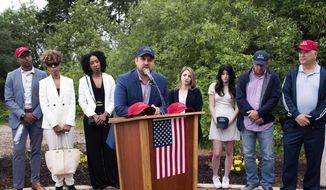 Brett Eagleson, who was 15 when his father Bruce was killed in the terrorist attack in New York, is among the speakers at a news conference Thursday, June 30, 2022 at the North Plains Veterans Park in North Plains, Ore. Thursday, June 30, 2022. The Saudi Arabia-backed LIV Golf tour teed off Thursday, angering a group of families who lost loved ones on Sept. 11 and want the Saudi government held to account for the terrorist attacks. (Beth Nakamura/The Oregonian via AP)