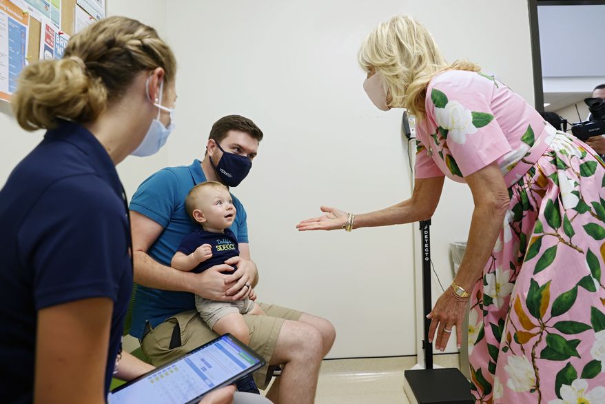 First lady Jill Biden greets Matthew Morgan and his almost 11-month-old Avery, as they wait for Avery to receive his first COVID-19 vaccination at the Henrico County Health Department East Clinic on Friday, July 1, 2022 in Richmond, Va. The visit sought to highlight the recent authorization and recommendation of COVID-19 vaccines for children under age five and was her first visit to a 6-month to 5-year-old pediatric COVID-19 vaccination clinic since the CDC recommended the use of COVID-19 vaccines for this age group. (Eva Russo/Richmond Times-Dispatch via AP)
