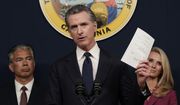 California Gov. Gavin Newsom displays a bill he just signed that shields abortion providers and volunteers in California from civil judgements from out-of-state courts during a news conference in Sacramento, Calif., Friday, June 24, 2022. Newsom angrily denounced the Supreme Court decision to overturn Roe v. Wade. (AP Photo/Rich Pedroncelli, File)