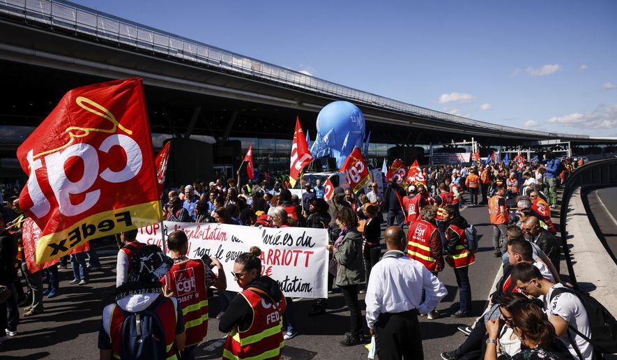 Unionists strikers demonstrate outside a terminal Friday, July 1, 2022 at Roissy airport, north of Paris. Flights from Roissy-Charles de Gaulle airport in Paris and other French airports faced disruptions Friday as airport workers held a strike and protests to demand salary hikes to keep up with inflation. It&#39;s the latest trouble to hit global airports this summer, as travel resurges after two years of virus restrictions. (AP Photo/ Thomas Padilla)