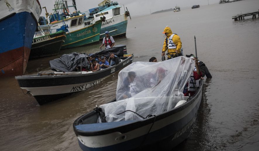 People leave the port by boat to return their communities amid the arrival of Tropical Storm Bonnie in Bluefields, Nicaragua, July 1, 2022. Tropical Storm Bonnie has formed over the Caribbean as it heads for a quick march across Central America and potential development into a hurricane after reemerging in the Pacific.  (AP Photo/Inti Ocon)
