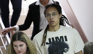 WNBA star and two-time Olympic gold medalist Brittney Griner is escorted to a courtroom for a hearing, in Khimki just outside Moscow, Russia, Friday, July 1, 2022. U.S. basketball star Brittney Griner is set to go on trial in a Moscow-area court Friday. The proceedings that are scheduled to begin Friday come about 4 1/2 months after she was arrested on cannabis possession charges at an airport while traveling to play for a Russian team. (AP Photo/Alexander Zemlianichenko) **FILE**