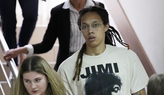 WNBA star and two-time Olympic gold medalist Brittney Griner is escorted to a courtroom for a hearing, in Khimki just outside Moscow, Russia, Friday, July 1, 2022. U.S. basketball star Brittney Griner is set to go on trial in a Moscow-area court Friday. The proceedings that are scheduled to begin Friday come about 4 1/2 months after she was arrested on cannabis possession charges at an airport while traveling to play for a Russian team. (AP Photo/Alexander Zemlianichenko) **FILE**