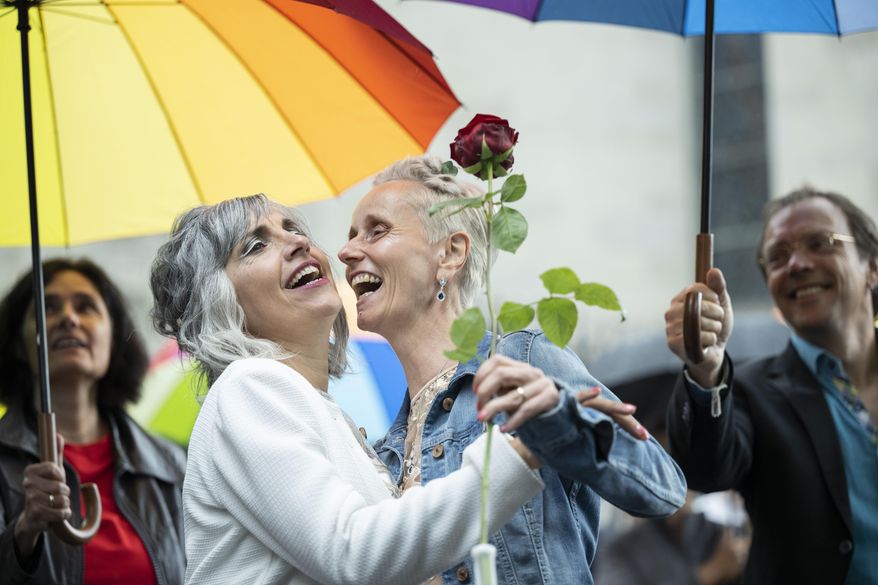 Annett Babinsky, right, and Laura Suarez celebrate their marriage at the registry office &#39;Amtshaus&#39; in Zurich, Switzerland, Friday, July 1, 2022.  After a yes vote in the &amp;quot;Marriage for All&amp;quot; vote last fall, from July 1, same-sex couples marriage for the first time in Switzerland. (Ennio Leanza/Keystone via AP)