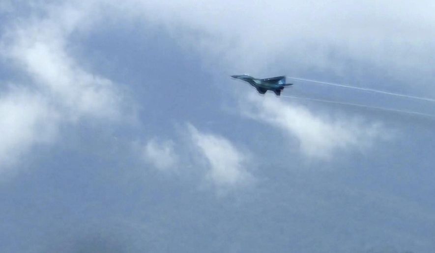 In this image taken from video, a fighter jet flies overhead and visible from Tak province, Thailand on Thursday, June 30, 2022. A Myanmar fighter jet crossed the border into Thailand&#x27;s airspace, prompting Thai air force jets to scramble and officials to order the evacuation of villages and classrooms, officials said. (AP Photo/Chiravut Rungjumrusrussamee)