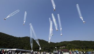 North Koran defectors release balloons carrying leaflets condemning North Korean leader Kim Jong Un and his government&#39;s policies, in Paju, near the border with North Korea, South Korea on  Oct. 10, 2014. North Korea suggested Friday, July 1, 2022 its COVID-19 outbreak began in people who had contact with balloons flown from South Korea, a highly questionable claim that appeared to be an attempt to hold its rival responsible amid increasing tensions. (AP Photo/Ahn Young-joon, File)