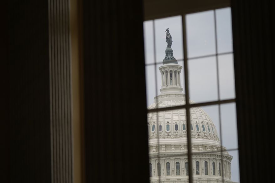 The U.S. Capitol dome is seen from a window in the Cannon House Office Building at the Capitol in Washington, June 21, 2022. Months ahead of the November midterms, congressional Democrats are suffering increasing criticism for keeping their district and state offices closed to constituents because of the coronavirus pandemic. (AP Photo/Patrick Semansky, File) **FILE**
