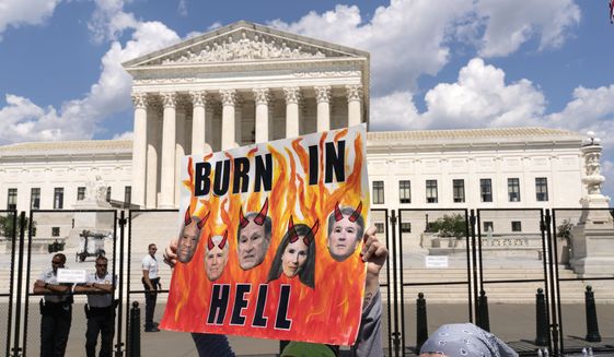 Abortion right activists protest outside the Supreme Court in Washington, Saturday, June 25, 2022. The Supreme Court has ended constitutional protections for abortion that had been in place nearly 50 years, a decision by its conservative majority to overturn the court&#39;s landmark abortion cases. (AP Photo/Jose Luis Magana)