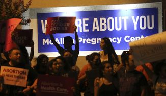 Demonstrators gather outside the Whole Women&#39;s Health clinic Friday, June 24,2022 in McAllen, Texas. The one clinic that provides abortion services in the Rio Grande Valley ceased providing abortions on Friday following the Supreme Court ruling overturning abortion. (Delcia Lopez/The Monitor via AP)