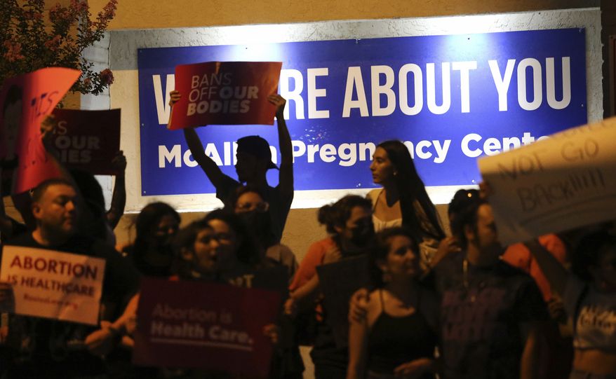 Demonstrators gather outside the Whole Women&#39;s Health clinic Friday, June 24,2022 in McAllen, Texas. The one clinic that provides abortion services in the Rio Grande Valley ceased providing abortions on Friday following the Supreme Court ruling overturning abortion. (Delcia Lopez/The Monitor via AP)