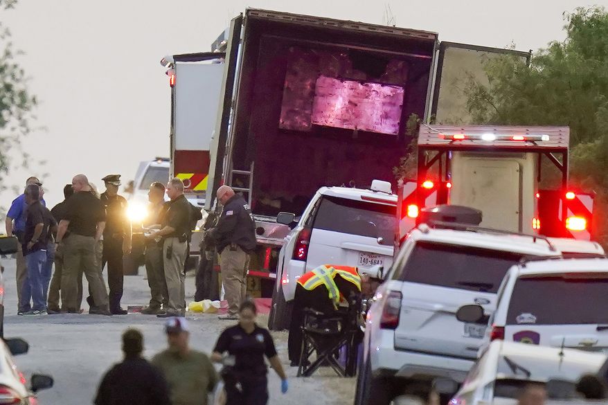 FILE - Police and other first responders work the scene where officials say dozens of people have been found dead and multiple others were taken to hospitals with heat-related illnesses after a semitrailer containing suspected migrants was found, Monday, June 27, 2022, in San Antonio. Following the horror of 53 migrants found dead or dying in Texas. The deadliest smuggling attempt in U.S. history illustrated the limitations of Texas Gov. Greg Abbott's massive border apparatus after 53 migrants were found dead or dying in a tractor-trailer in San Antonio. (AP Photo/Eric Gay, File)