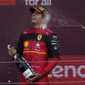 Ferrari driver Carlos Sainz of Spain celebrates on the podium after winning the British Formula One Grand Prix at the Silverstone circuit, in Silverstone, England, Sunday, July 3, 2022. (AP Photo/Matt Dunham)